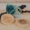 Abrebotellas de bambú personalizado con nombre Silvia grabado a láser, usado como marcasitio de boda junto a flores secas azules